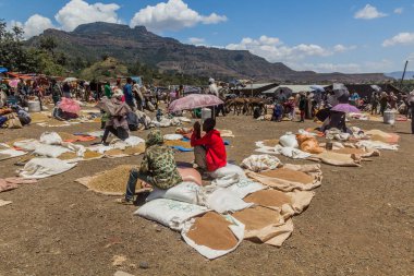 LALIBELA, ETHIOPIA - MARCH 30, 2019: Grains seller at the Saturday market in Lalibela, Ethiopia