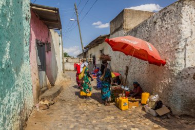 HARAR, ETHIOPIA - APRIL 9, 2019: Local women carry a fiewwood in the old town of Harar, Ethiopia