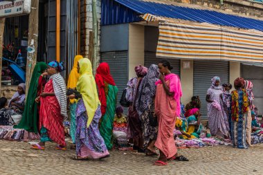 HARAR, ETHIOPIA - APRIL 8, 2019: Colorful women walking on a street in Harar, Ethiopia