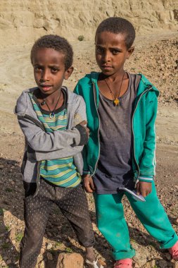 LALIBELA, ETHIOPIA - MARCH 30, 2019: Children on a rural road near Lalibela, Ethiopia