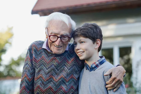 Smiling Senior Man Arm Grandson Backyard — Stock Photo, Image