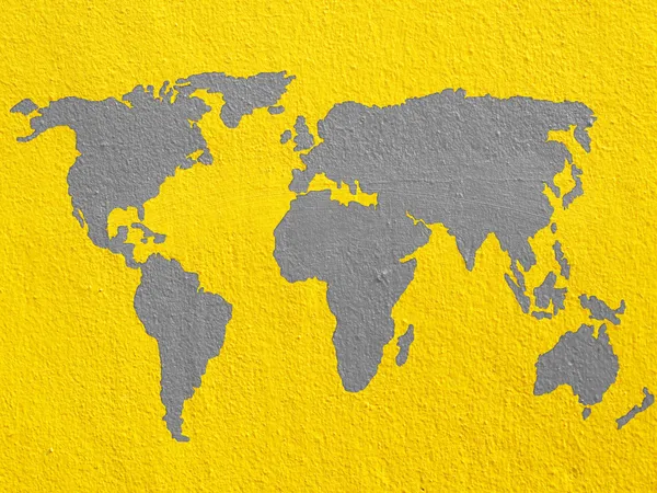 Mapa świata na ścianie żółty cementu — Zdjęcie stockowe