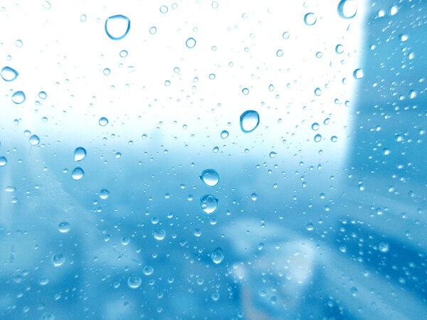 Close-up of water drops on glass surface as background