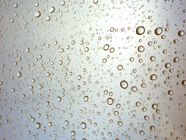 Close-up of water drops on glass surface as background — Stock Photo, Image