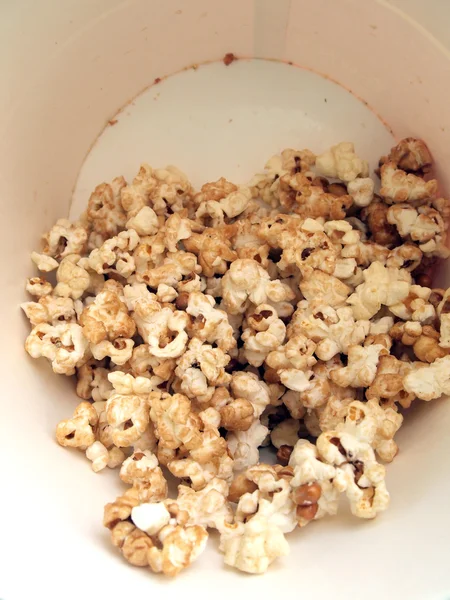 Pop corn in caramel syrup in the paper box — Stock Photo, Image