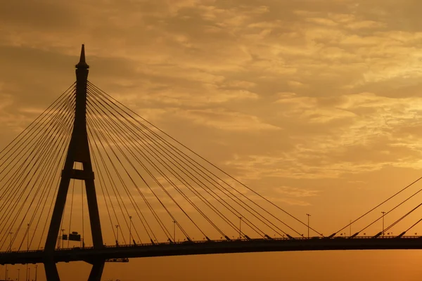 Black silhouette of suspended bridge during sunrise — Stock Photo, Image