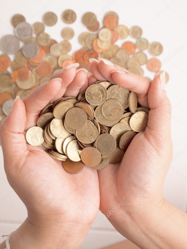 a lot of coins in the hands of woman