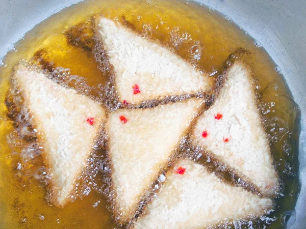 Country fried bread in hot oil — Stock Photo, Image