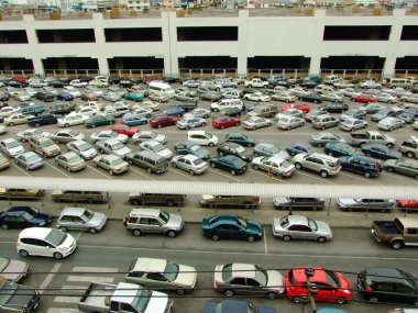 BANGKOK - MARCH 14: Cars parked at a park and side lot at a BTS station in Chatuchak district on March 14, 2009 in Bangkok, Thailand. The government has promoted park and ride to reduce traffic conges clipart