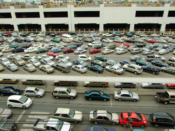 BANGKOK - MARCH 14: Cars parked at a park and side lot at a BTS station in Chatuchak district on March 14, 2009 in Bangkok, Thailand. The government has promoted park and ride to reduce traffic conges