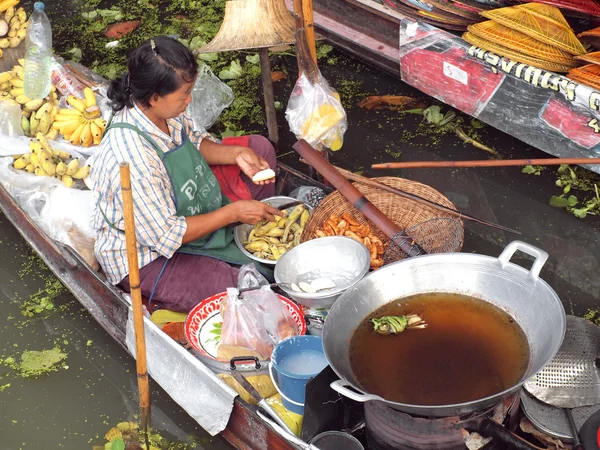 RATCHABURI, THAILANDIA-SETTEMBRE 2013: Le popolazioni locali vendono frutta, cibo e prodotti al mercato galleggiante di Damnoen Saduak, il 7 settembre 2013 a Ratchaburi, Thailandia. Dumnoen Saduak è un turista molto popolare — Foto Stock