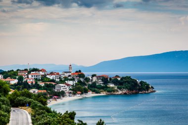 Town of Gradac on Makarska Riviera and Island Brac in Background clipart