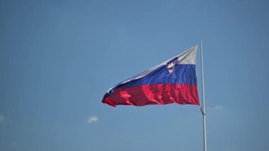 Slovenia National Flag Waving on poleSlovenian national flag against sunny blue sky background, Republic of Slovenia