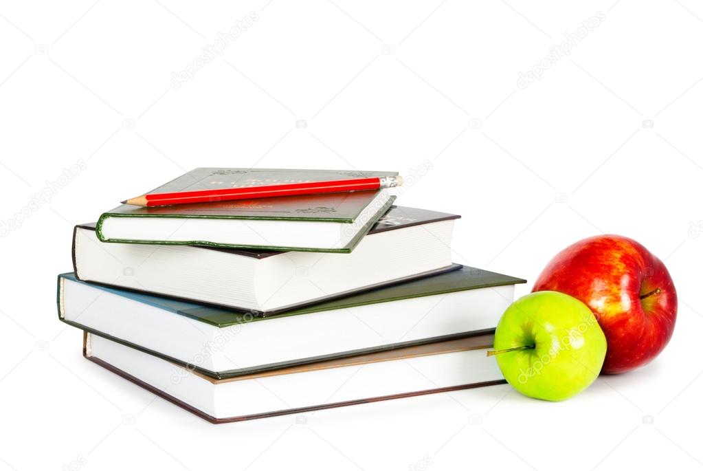 Apples and pencil on pile of books
