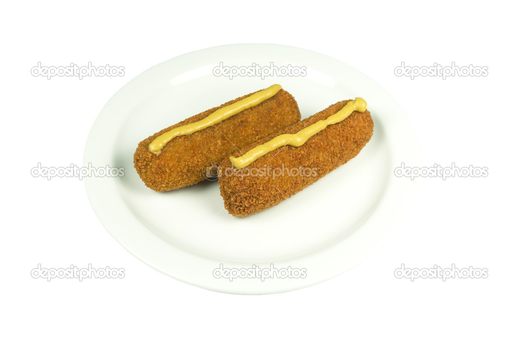 Plate with two beef croquettes with mustard.