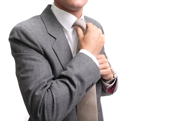 Young businessman fastening tie — Stock Photo, Image