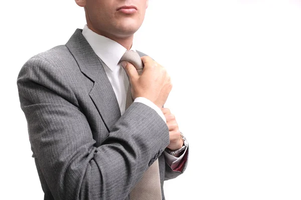 Young businessman fastening tie — Stock Photo, Image