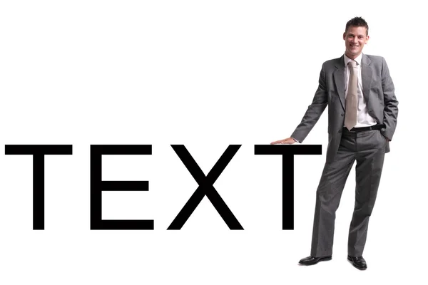 Ung affärsman står över vit bakgrund, lutad mot text — Stockfoto