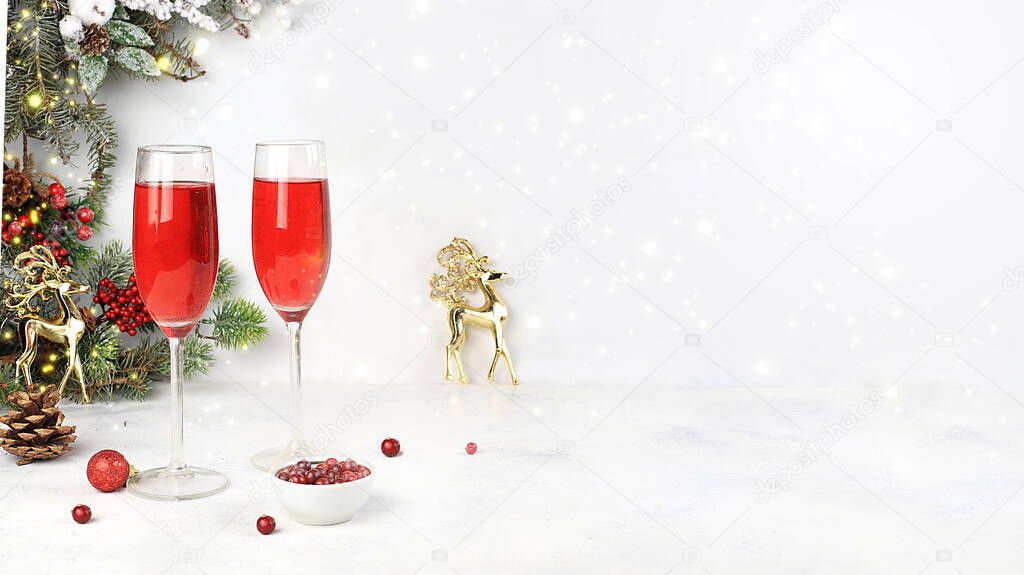 Christmas alcoholic cocktail with cranberry and cinnamon spice, red mimosa cocktail with champagne, warming winter drink in the cold season, christmas festive grog, winter composition, selective focus