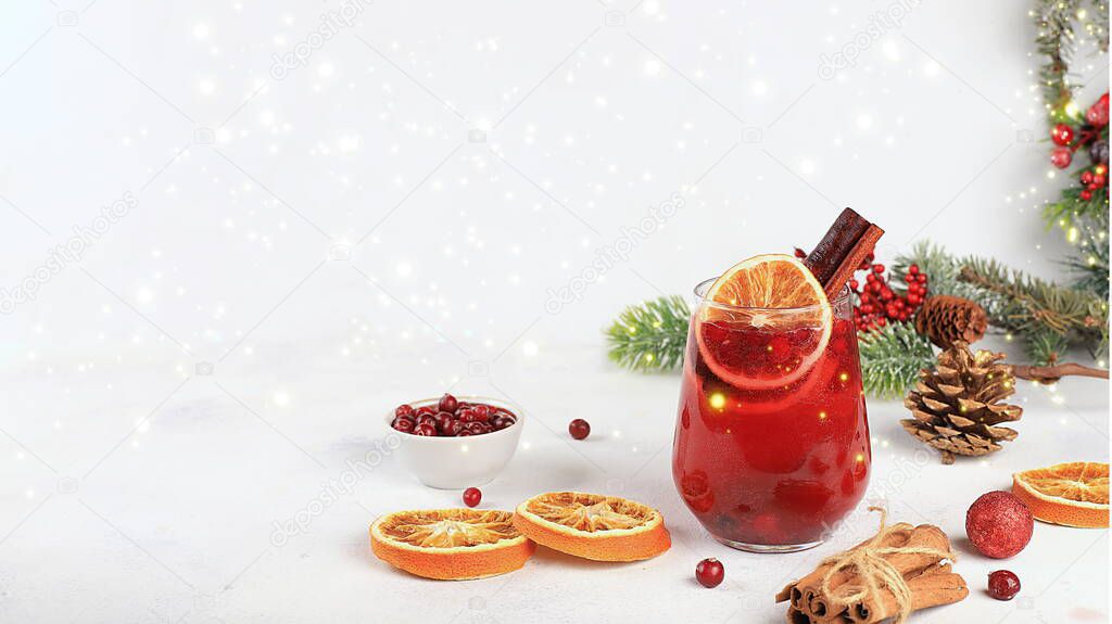 Strong alcoholic or non-alcoholic cocktail with cranberry and cinnamon spices, warming winter drink in the cold season, christmas festive grog, winter composition, selective focus