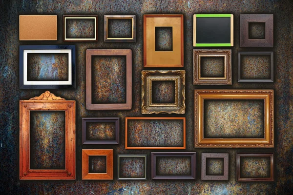 Grunge wall full of old frames — Stock Photo, Image