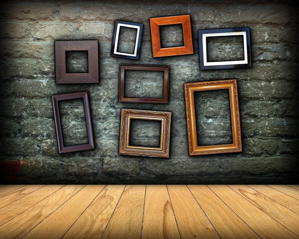 Scratched wall full of wood frames — Stock Photo, Image