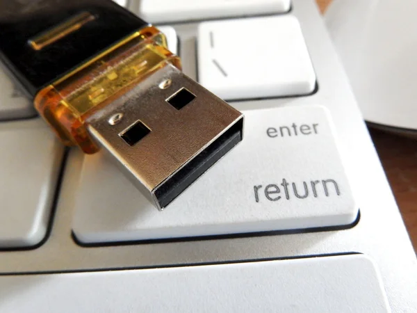 Flash drive on keyboard buttons — Stock Photo, Image