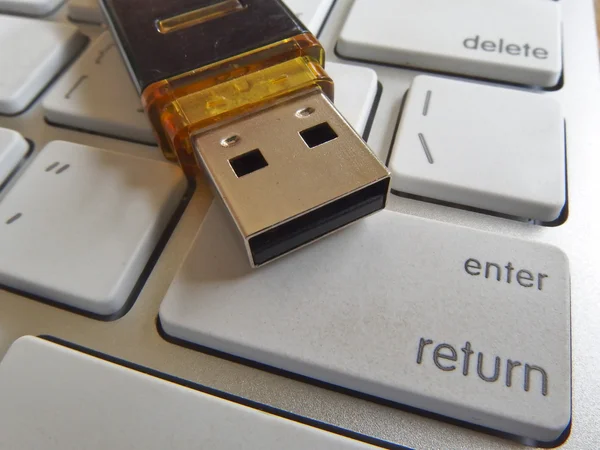 Flash drive on keyboard buttons — Stock Photo, Image