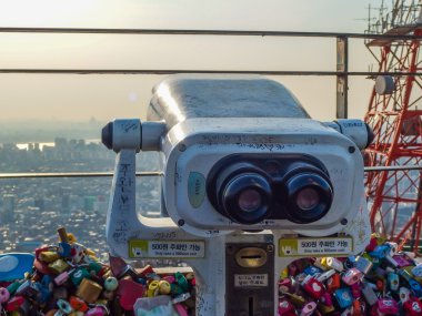 SEOUL, SOUTH KOREA - MARCH 07: binoculars on Namsan Tower, also  clipart