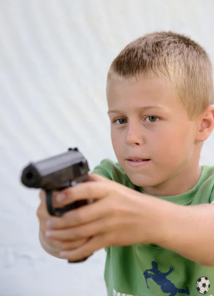 Jongen schiet een pistool — Stockfoto