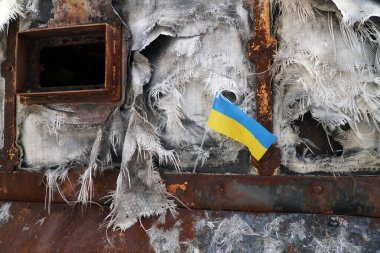 Ukrainian flag on a destroyed Russian military vehicle