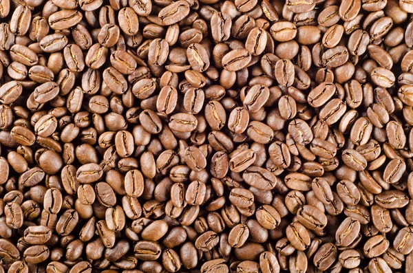 Granos de café expreso como fondo o textura — Foto de Stock