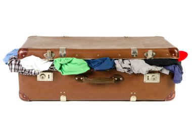 old suitcase full with clothes before white background clipart