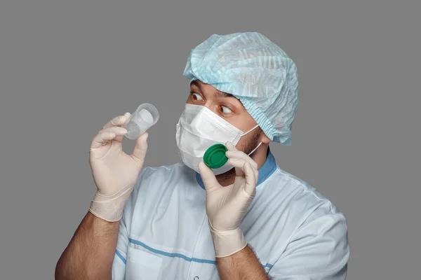 Young doctor with container for analysis — Stock Photo, Image