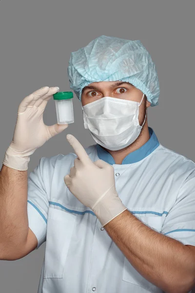 Young doctor with container for analysis — Stock Photo, Image