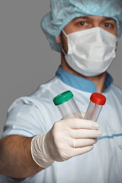 Young doctor with container for analysis — Stock Photo, Image