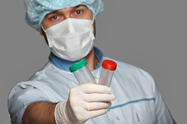 Young doctor with container for analysis — Stock Photo, Image