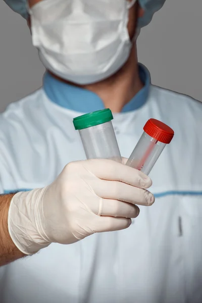 Young doctor with container for analysis — Stock Photo, Image