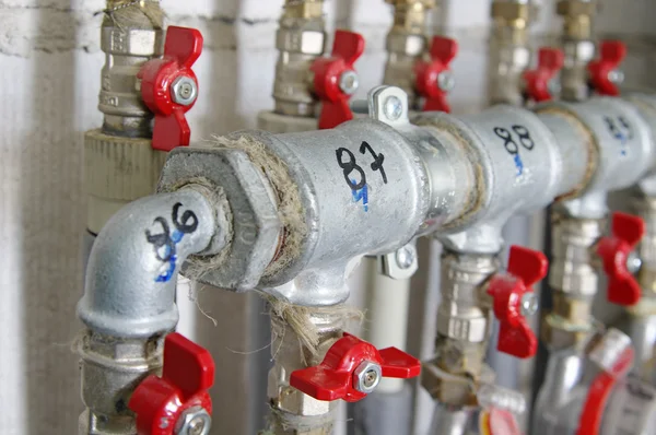 Pipes and valves for warm watter — Stock Photo, Image