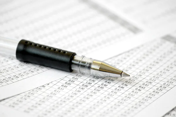 Ballpoint Pen on table with numbers — Stock Photo, Image