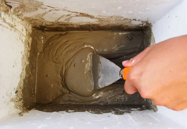 Cement powder Mixed by hand and Metal trowel. Wall Painting Preparation at home
