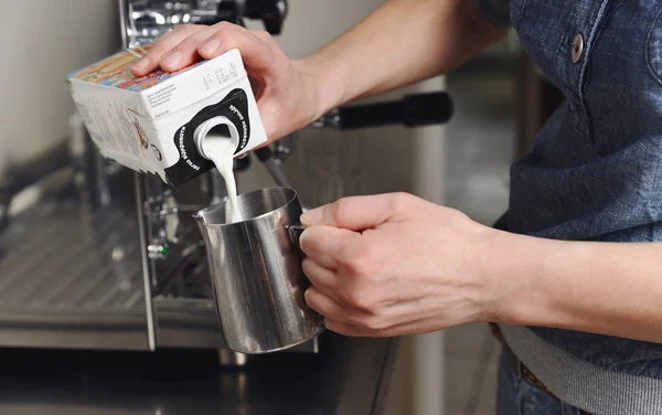 Female hands pour milk — Stock Photo, Image