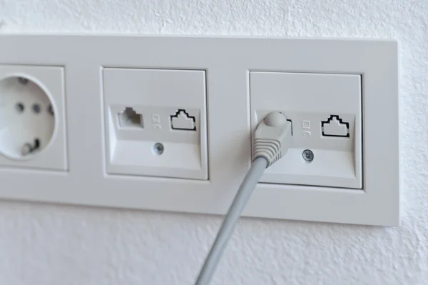 Network cable into an outlet — Stock Photo, Image