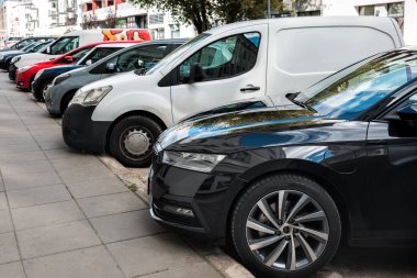 Various cars are parked along the road.