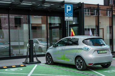 Warsaw, Poland- 09.01.2022: Electric car in the parking lot with a charging station.