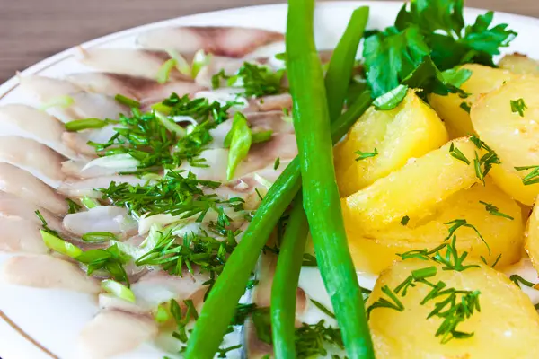 Potatoes with herring and greens — Stock Photo, Image