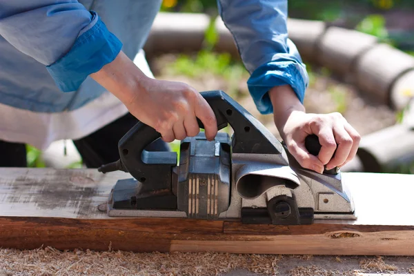 Carpenter with electric planes — Stock Photo, Image