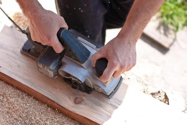 Carpenter with electric planes — Stock Photo, Image