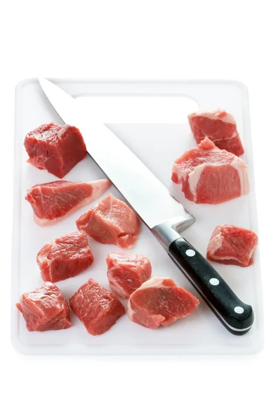 Raw cubes lamb on a chopping board — Stock Photo, Image