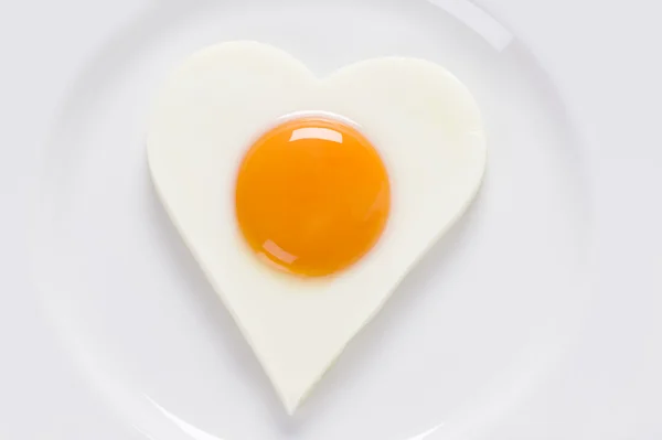 Fried egg in a heart shape — Stock Photo, Image